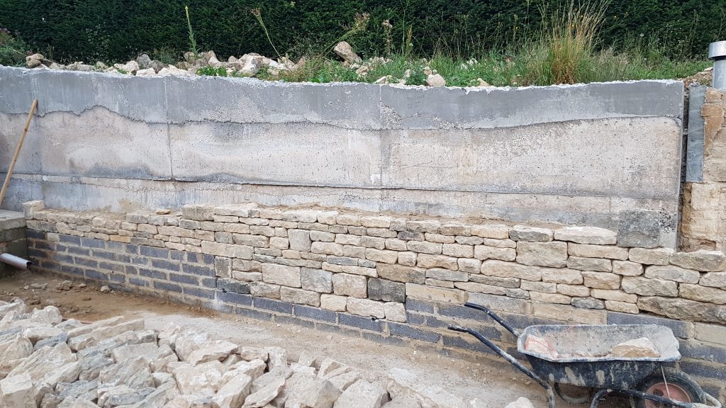 Dry stone effect facing on a concrete retaining garden wall in Oakridge Lynch, Stroud, Cotswolds