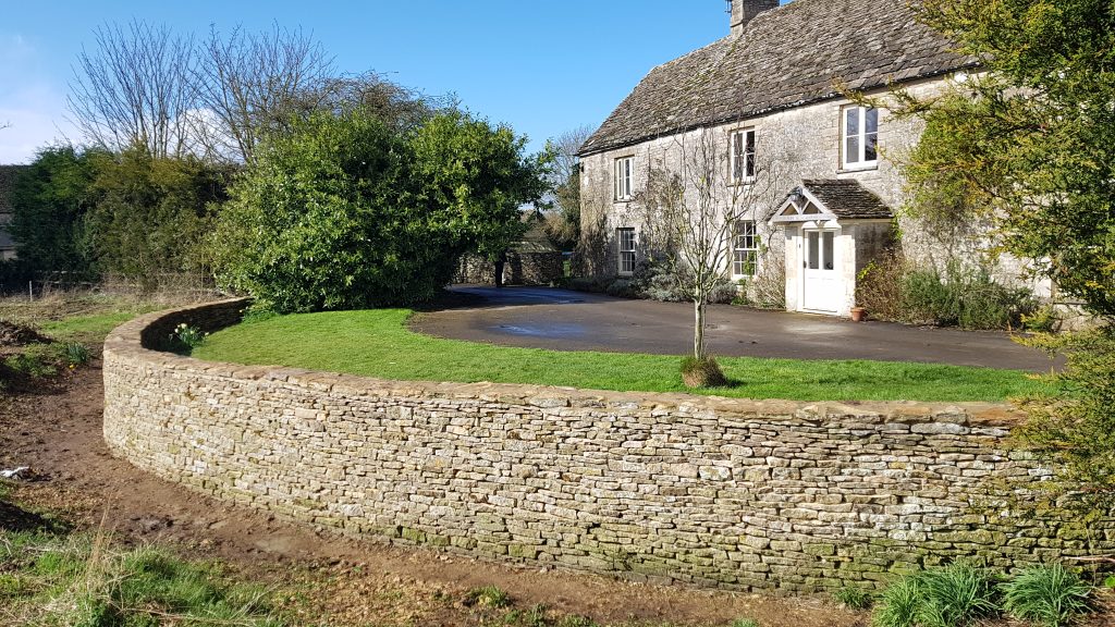 Repair and rebuild of a dry stone retaining wall and ha-ha in Kemble, Cirencester, Cotswolds