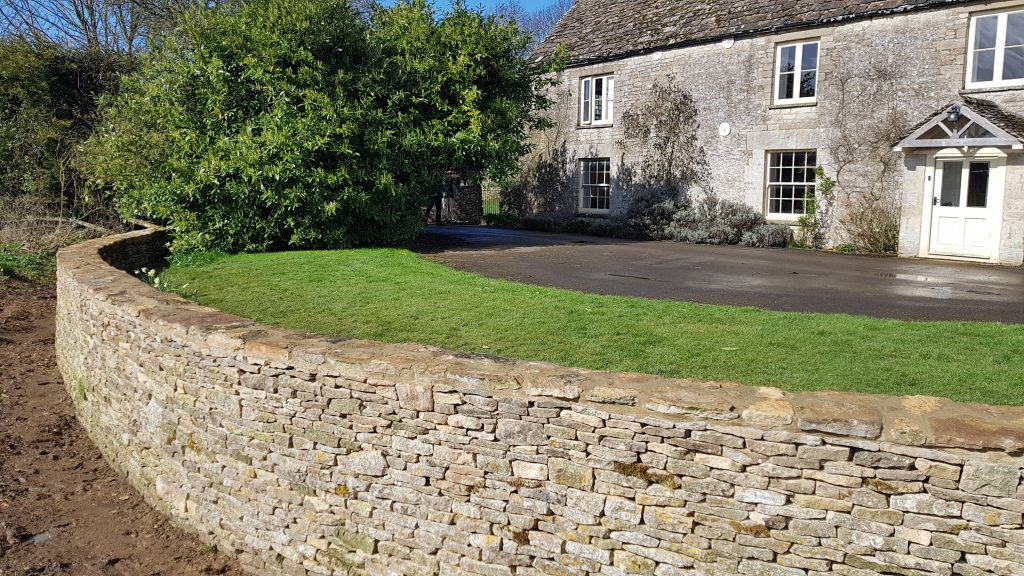 Repair and rebuild of a dry stone retaining wall and ha-ha in Kemble, Cirencester, Cotswolds