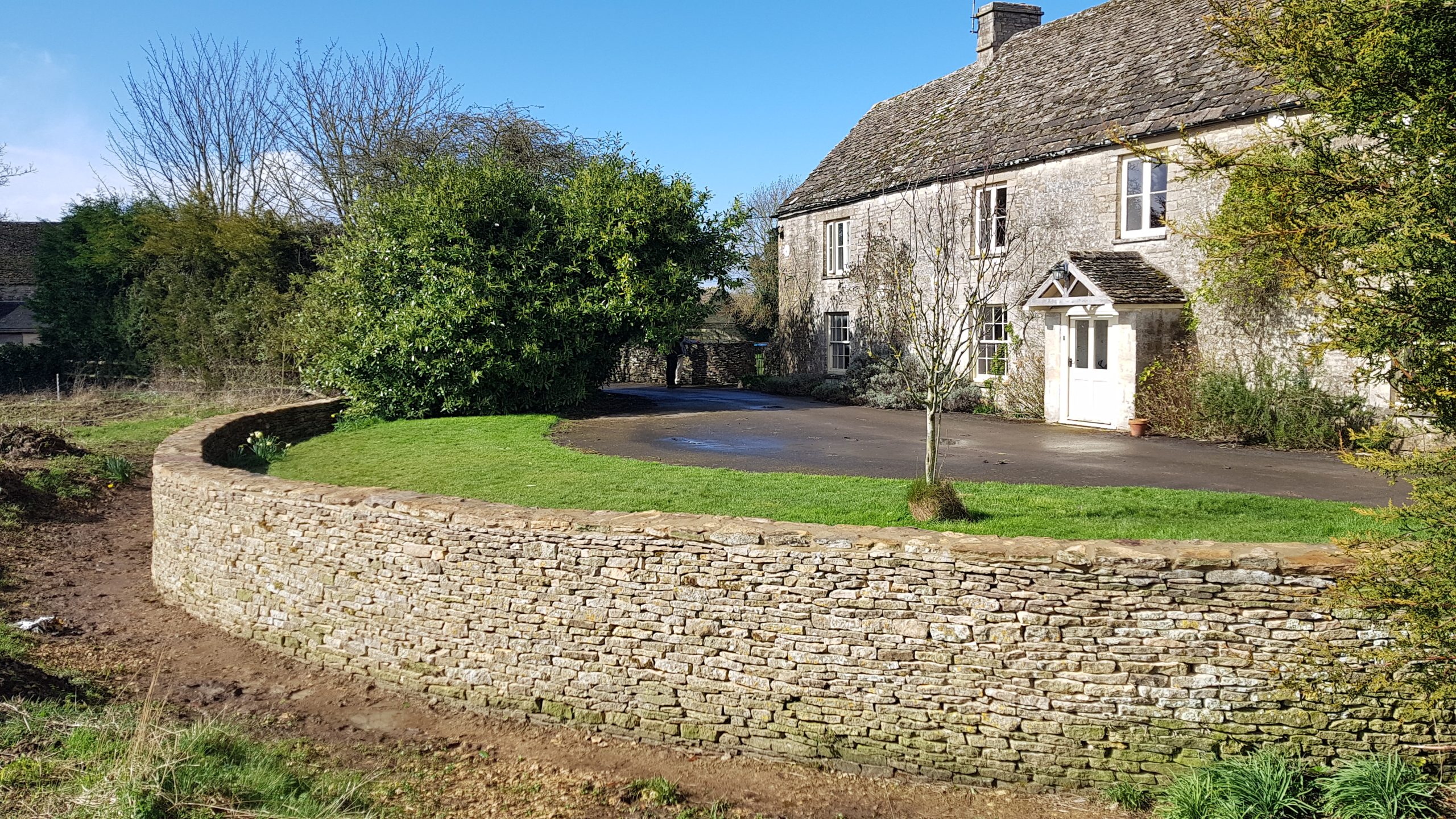 Repair and rebuild of a dry stone retaining wall and ha-ha in Kemble, Cirencester, Cotswolds