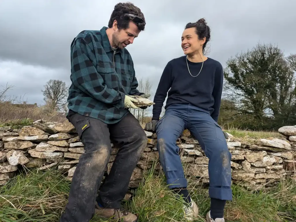 dry stone habitats joe and leah dry stone wallers professional dswa specialists contractors sat on a wall near Stroud, Gloucestershire