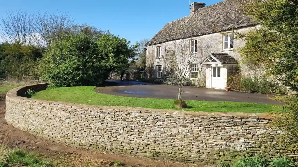 Completed dry stone wall restoration of ha-ha in Kemble near Cirencester.