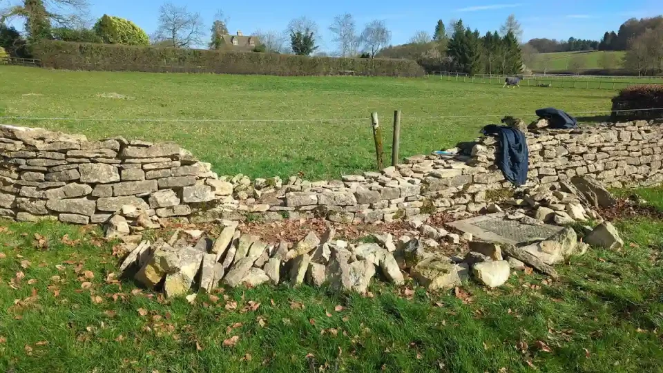 Dry stone wall repair in progress on an old dry stone field wall in Nailsworth near Stroud.